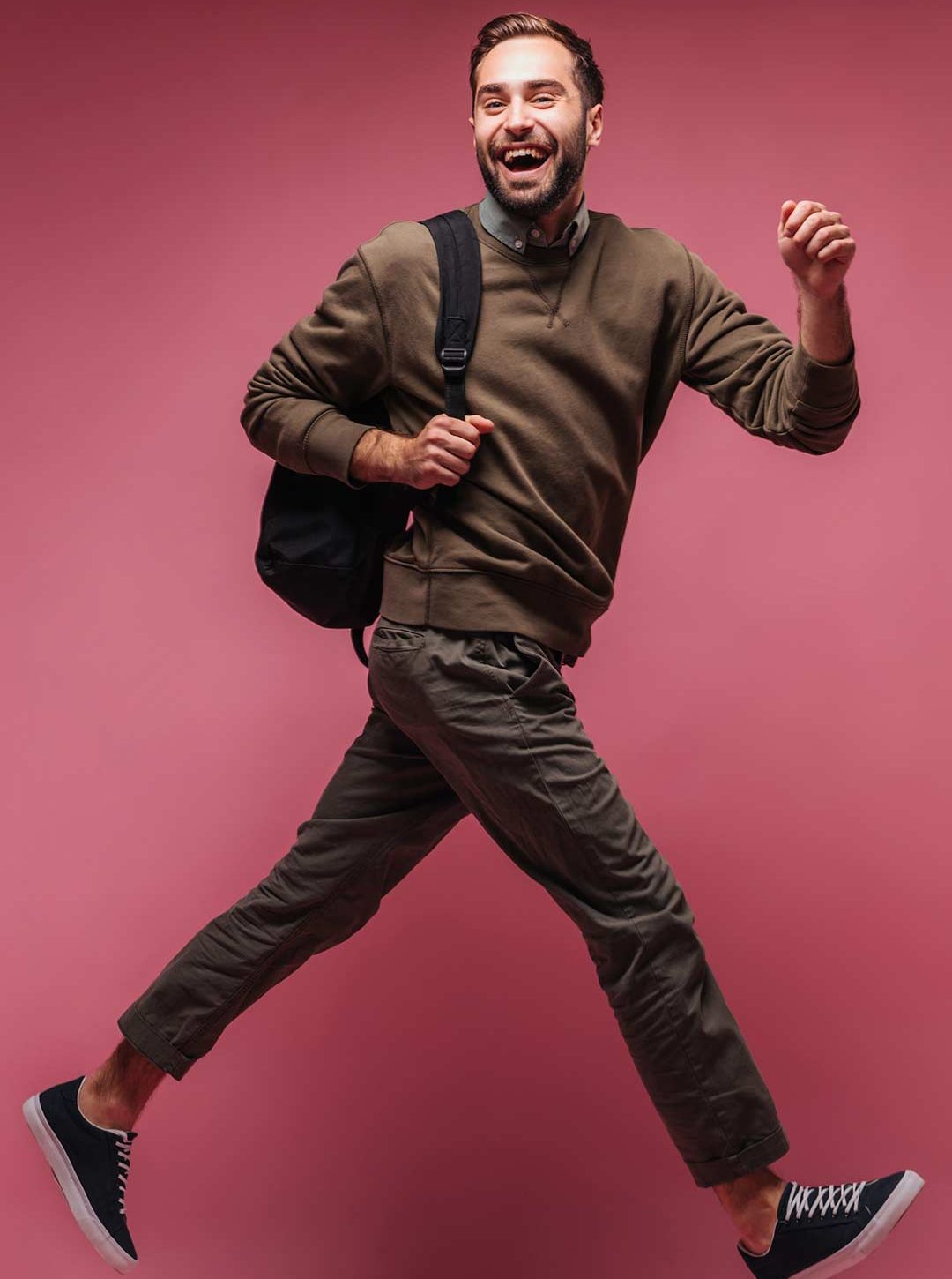 guy-in-brown-outfit-smiles-and-moves-on-isolation-web